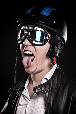 Angry retro biker sticking his tongue out.